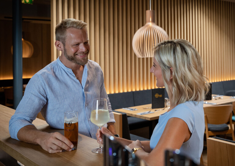 Ein Paar genießt einen Drink an der Bar in der Eventlocation bei Villach